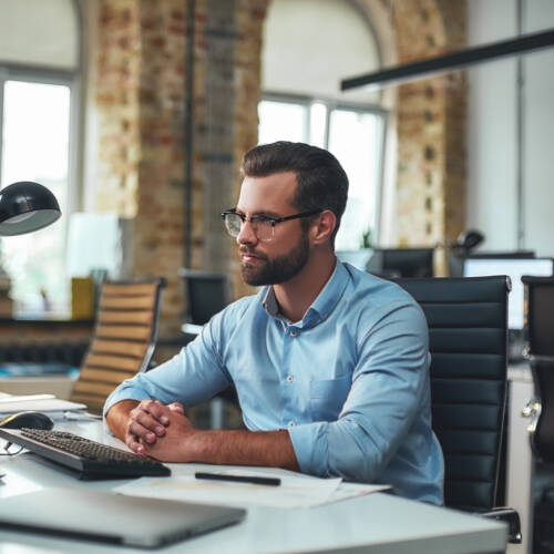 Office administrator working at computer in a modern professional office in Ireland