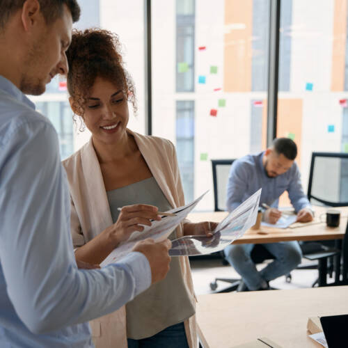 Office administrators reviewing documents in professional workplace
