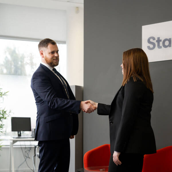Two people shaking hands in Staffline office