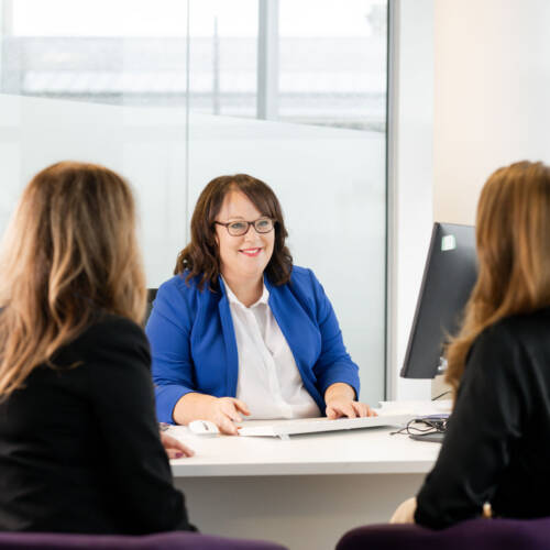 Woman conducting an interview with two people