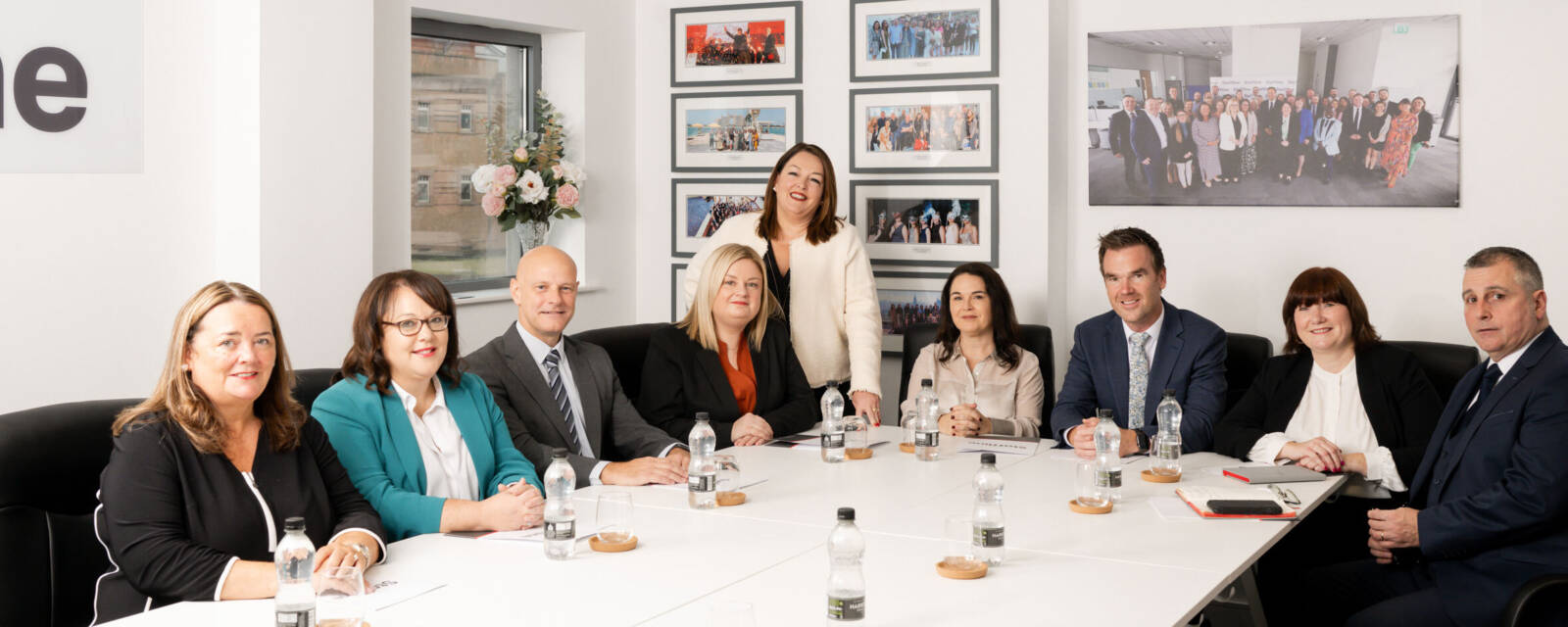 Group of Staffline team smiling for a photo in their boardroom