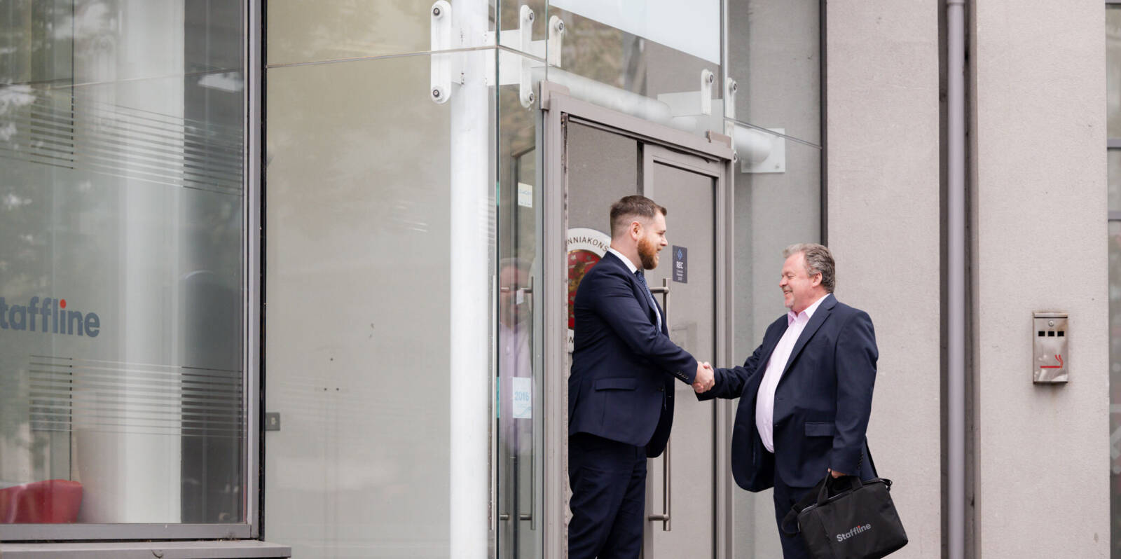 Two people greeting each other outside Staffline office