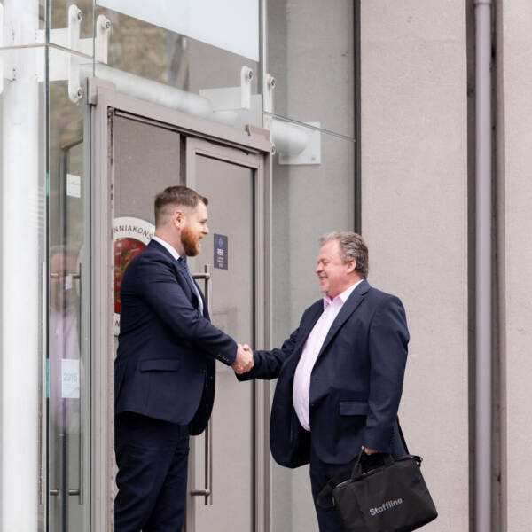 Two people greeting each other outside Staffline office