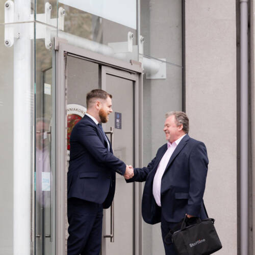 Two people greeting each other outside Staffline office