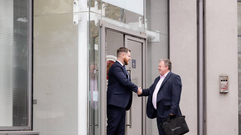 Two people greeting each other outside Staffline office